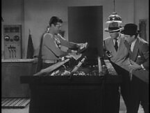 Superman retrieves the engraving plates from the acid vat while Henderson and Marcel look on