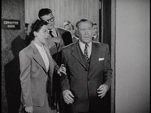 Clark and Lois follow the disoriented Wagner as he leaves the courtroom - Lois grabs his arm