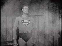 Superman standing in the gun smoke, unharmed