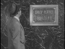 Clark at the outside of the Daily Planet building