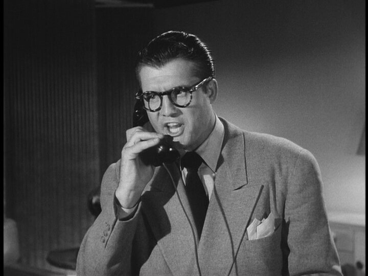 Clark Kent (portrayed by George Reeves in the Adventures of Superman) yelling angrily on the phone