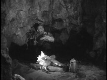 Dr. Jan Moleska hiding in the cave with a fire