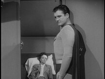 Superman stands near Lois, who is unconscious with a bandage on her head